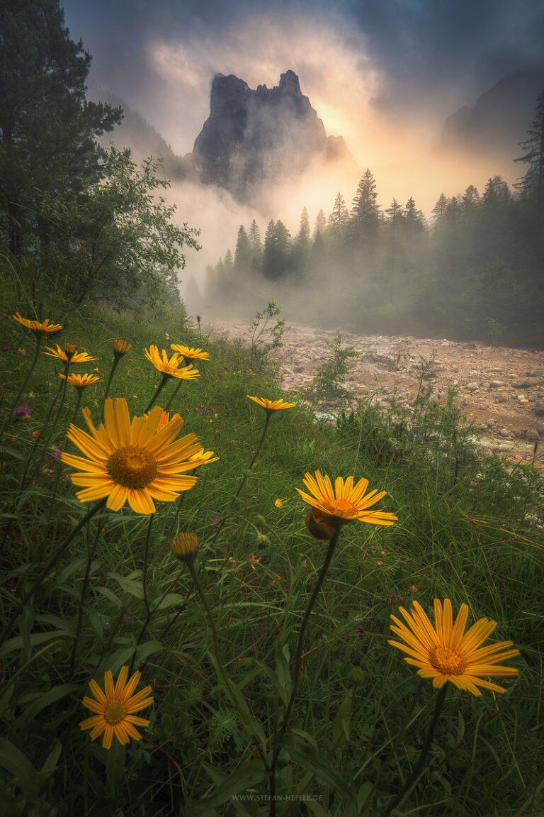 Hidden Valley in the southern Dolomites in humid summer weather with fog and clouds