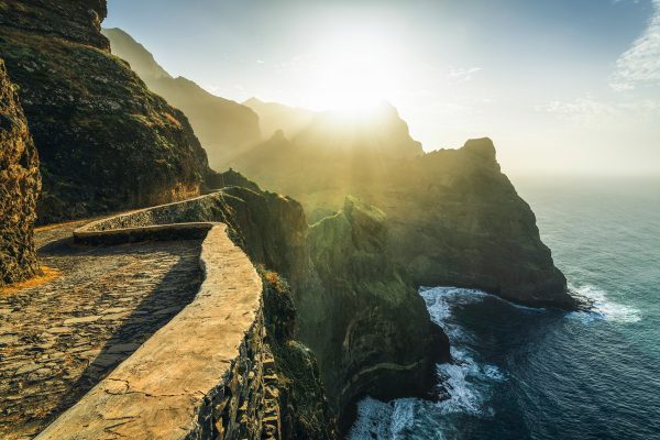 Hiking trail with gigantic mountain-sea backdrop in the golden sunset light on the north coast of Santo Antao - Cape Verde