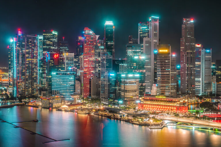 Part of the Singapore skyline in bright, crisp colours against a dark sky and a beautiful reflection in the marina. Photographed from the 31st floor